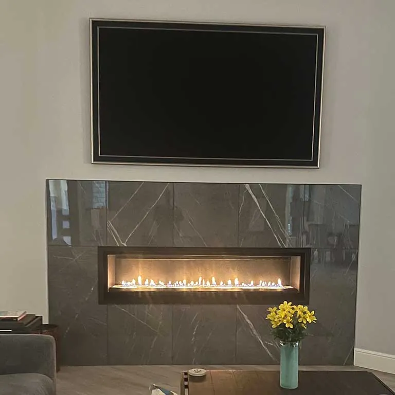 Completed CDR fireplace installation with stone surround