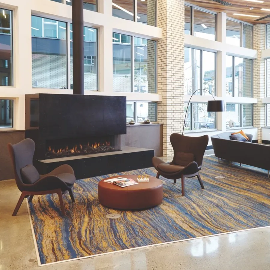 See-through commercial fireplace with safety screen in a hospitality space