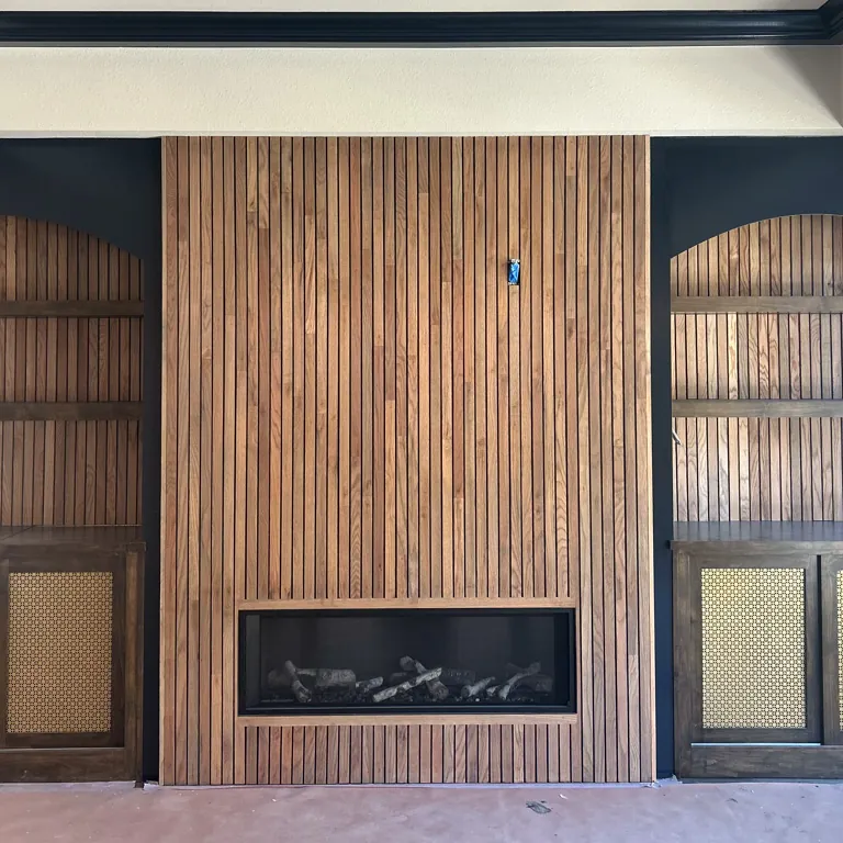 Dark fireplace wall balanced with warm wood shelving