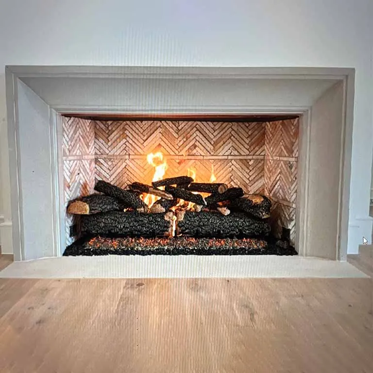 Gas fireplace with chevron brick surround