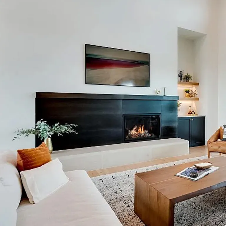 Modern linear fireplace set in a warm wood feature wall